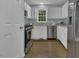 Contemporary kitchen boasting white cabinets, stainless steel appliances, and hardwood floors at 900 Finchurch Cir, Wake Forest, NC 27587