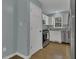 Modern kitchen with white cabinets, stainless steel appliances, and sleek hardwood floors at 900 Finchurch Cir, Wake Forest, NC 27587