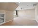 Finished attic features a ceiling fan and window with curtains, offering a bright, usable space at 97 Rand Rd, Raleigh, NC 27603
