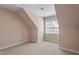 The finished attic space with window and neutral walls offers versatile living options at 97 Rand Rd, Raleigh, NC 27603