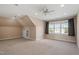 Spacious attic with recessed lights, ceiling fan and window with curtains, perfect for a playroom or office at 97 Rand Rd, Raleigh, NC 27603