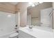 Bathroom with a combination tub and shower, a white vanity, and a large mirror at 97 Rand Rd, Raleigh, NC 27603