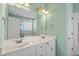 Double vanity bathroom with a large mirror and white cabinets at 97 Rand Rd, Raleigh, NC 27603