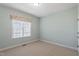 Cozy bedroom features light blue walls and a window with floral print valance, filled with natural light at 97 Rand Rd, Raleigh, NC 27603