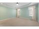 Bright bedroom with carpet, tray ceiling, and two windows at 97 Rand Rd, Raleigh, NC 27603
