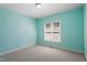 Carpeted bedroom with light blue walls and a window providing ample natural light at 97 Rand Rd, Raleigh, NC 27603