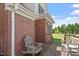 Wooden deck offers a relaxing outdoor space with weathered chairs and brick accents at 97 Rand Rd, Raleigh, NC 27603