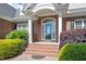 Inviting front entrance with brick steps, decorative door and manicured greenery at 97 Rand Rd, Raleigh, NC 27603