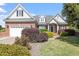 Charming brick home with manicured landscaping and a two-car garage, showcasing curb appeal at 97 Rand Rd, Raleigh, NC 27603
