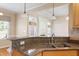 Kitchen with granite countertops and stainless steel sink, looking into the living room at 97 Rand Rd, Raleigh, NC 27603