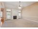Bright living room with a fireplace, ceiling fan, and access to the outside at 97 Rand Rd, Raleigh, NC 27603