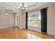 Open living room with hardwood floors, large windows, and decorative molding at 97 Rand Rd, Raleigh, NC 27603