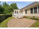 Paver patio and outdoor living space with sunroom and black metal fence at 9701 Precious Stone Dr, Wake Forest, NC 27587
