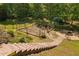 A backyard featuring a garden area, fire pit and views of the encompassing forest at 9701 Precious Stone Dr, Wake Forest, NC 27587