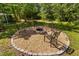Relaxing backyard fire pit area with chairs, a fire pit, and a hammock at 9701 Precious Stone Dr, Wake Forest, NC 27587