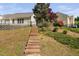 View of the backyard with wood steps up to the house and black metal fence at 9701 Precious Stone Dr, Wake Forest, NC 27587