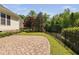 Paver patio and backyard with mature trees and a black metal fence at 9701 Precious Stone Dr, Wake Forest, NC 27587