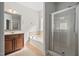 Bathroom featuring a glass shower, soaking tub, and wood vanity at 9701 Precious Stone Dr, Wake Forest, NC 27587