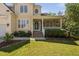 Charming two-story home featuring a well-maintained lawn and a welcoming front porch with stone accents at 9701 Precious Stone Dr, Wake Forest, NC 27587