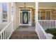 Inviting front porch with stone accents and a decorative front door leading to the home's entrance at 9701 Precious Stone Dr, Wake Forest, NC 27587
