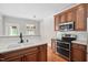 Well-lit kitchen featuring stainless steel appliances, bright counter tops, modern cabinets, and wood floors at 9701 Precious Stone Dr, Wake Forest, NC 27587