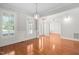 Open-concept living area featuring hardwood floors, neutral walls, and ample natural light from large windows at 9701 Precious Stone Dr, Wake Forest, NC 27587