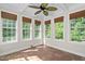 Bright sunroom with beamed ceiling, many windows, and tile flooring at 9701 Precious Stone Dr, Wake Forest, NC 27587