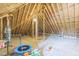 Large, unfinished attic showcasing exposed beams and ample space, ideal for various development opportunities at 1 Plowlan Ct, Durham, NC 27707