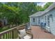Relaxing back deck with seating, perfect for outdoor gatherings, set against a backdrop of lush greenery at 1 Plowlan Ct, Durham, NC 27707