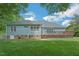 Expansive backyard featuring a wooden deck, well-maintained lawn and mature landscaping at 1 Plowlan Ct, Durham, NC 27707