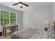 Relaxing bedroom features a desk with chair, window and a ceiling fan at 1 Plowlan Ct, Durham, NC 27707