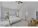Bedroom features a plush bed, a ceiling fan, and a glimpse into the walk-in closet at 1 Plowlan Ct, Durham, NC 27707