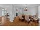 Elegant dining room with hardwood floors and a classic chandelier at 1 Plowlan Ct, Durham, NC 27707