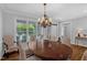 Elegant dining room with hardwood floors, chandelier, and natural light at 1 Plowlan Ct, Durham, NC 27707
