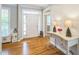 Bright entryway with hardwood floors, decorative table and natural light at 1 Plowlan Ct, Durham, NC 27707