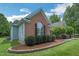 Charming home exterior with brick accents, manicured landscaping, and lush green lawn at 1 Plowlan Ct, Durham, NC 27707