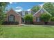 Charming brick home with a well-manicured lawn and mature landscaping at 1 Plowlan Ct, Durham, NC 27707