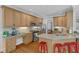 Well-lit kitchen featuring granite counters, stainless appliances and light wood cabinets at 1 Plowlan Ct, Durham, NC 27707