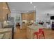Open kitchen with granite countertops, stainless steel appliances and red barstools at 1 Plowlan Ct, Durham, NC 27707