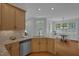 Open kitchen featuring stainless appliances, granite countertop island, and hardwood floors at 1 Plowlan Ct, Durham, NC 27707