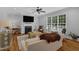 Comfortable living room with a fireplace and natural light from a large window at 1 Plowlan Ct, Durham, NC 27707
