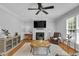 Cozy living room with fireplace, flat screen TV, ceiling fan and decorative furniture at 1 Plowlan Ct, Durham, NC 27707