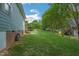 Large, flat backyard with a well-maintained lawn, backing up to mature trees at 1 Plowlan Ct, Durham, NC 27707