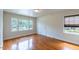 Bright bedroom with hardwood floors, white walls, multiple windows for natural light, and a closet for ample storage at 1013 Graham St, Burlington, NC 27217