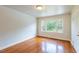 Cozy bedroom featuring gleaming hardwood floors, fresh white walls, and a large window offering ample natural light at 1013 Graham St, Burlington, NC 27217