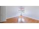 Bedroom with window with blinds, light walls, and wood-look laminate flooring at 1013 Graham St, Burlington, NC 27217