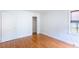 Bedroom with window with blinds, light walls, and wood-look laminate flooring at 1013 Graham St, Burlington, NC 27217