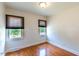 Bedroom with two windows with blinds, light walls, and wood-look laminate flooring at 1013 Graham St, Burlington, NC 27217