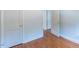 Hallway with light walls, and wood-look laminate flooring at 1013 Graham St, Burlington, NC 27217