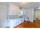 Bright kitchen featuring white cabinets, laminate countertops and stainless steel sink at 1013 Graham St, Burlington, NC 27217